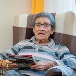 Entspannte Seniorin beim Lesen im Sessel